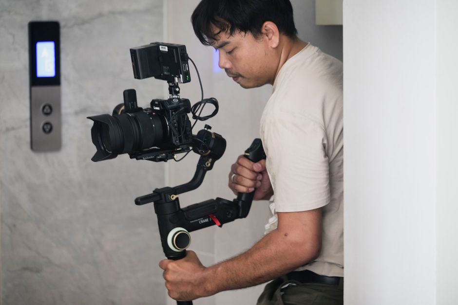 Professional wedding videographer holding a camera